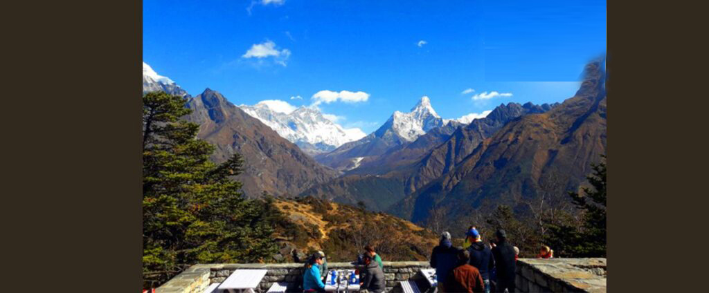 Tourists sipping tea with Everest view